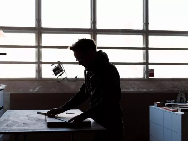 carpenter-measuring-wood-in-workshop-2021-08-29-00-54-26-utc (1) Carpenter measuring wood in workshop for a pool table